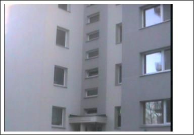 Renovuoto daugiabučio S. Konarskio g. 10 fasadas su langais, įėjimu ir šviesiai pilku tinku.